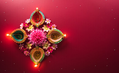 Happy Diwali - Clay Diya lamps lit during Diwali, Hindu festival of lights celebration. Colorful traditional oil lamp diya on red background