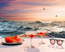 Romantic Evening Sea Trip. Cocktail Glasses, Fruit On Deck Of Private Yacht During Honeymoon Holidays, Outdoors. Love, Travel, Vivid Impressions