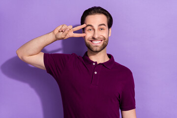 Wall Mural - Photo of cute funky cheerful male showing v-sign on eye playful mood fool around isolated on violet color background