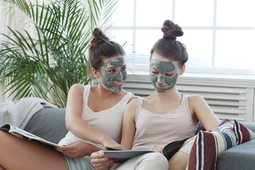 Two friends bonding over a relaxing facial treatment on the sofa, captured in a fun and trendy lifestyle stock photo.