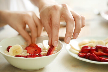 Preparing Fresh Strawberry and Banana Fruit Salad in a Bright Kitchen