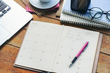 Wall Mural - agenda, planner book, laptop, pencil, and cup of coffee placed on office desk. diary for organizer t