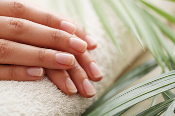 Beautiful woman hands with manicure isolated on light background.