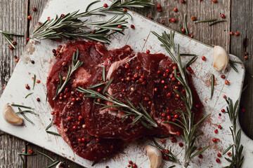 Raw fresh red meat with rosemary and spices