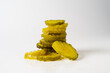 stack of crinkle cut dill pickle chips isolated in white background
