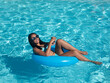 © Juan - Merry young woman chilling in pool