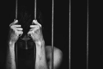 prison man crime in gaol, hold hand iron bar jail, punishment convict in justice law, cage for lock freedom, concept for stress, violence