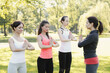 © racool_studio - A group of healthy, beautiful, athletic women doing yoga in the park.