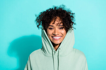 Wall Mural - Photo of nice satisfied young person toothy beaming smile wear head hood isolated on vivid aquamarine color background