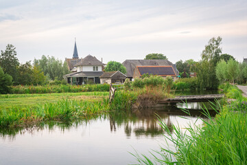 Wall Mural - idyllic image of the village of reeuwijk-dorp and the surrounding watery countryside