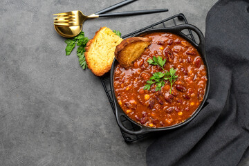 Wall Mural - Bean and corn soup or ragout, red bean stew on a dark background. Food Protein Vegan dis