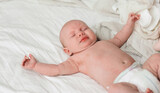 Fototapeta  - Adorable little baby lying on bed