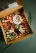 Charcuterie Box full of fresh cheeses, fruits, and meats
