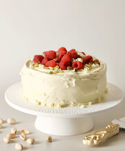 Pistachio And Raspberry Cake With White Frosting Icing