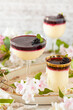 © The Picture Pantry - Three glasses of lemon posset topped with blackberry sauce.
