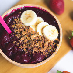 Wall Mural - Açaí bowl with granola, tropical fruits, banana, raspberry, condensed milk and cereal. Close up. 3D representation
