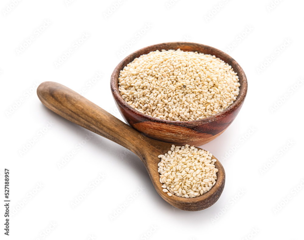 Wooden bowl and spoon with sesame seeds on white background