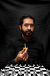 © Narayan - latin man with beard holding chess king, leadership concept