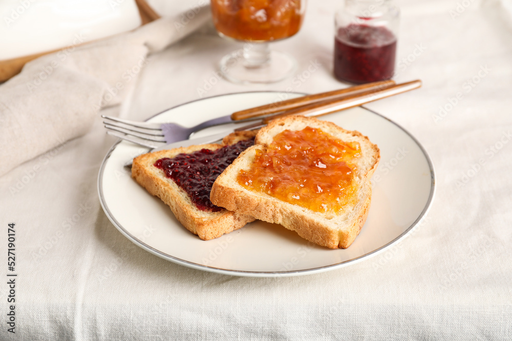 Plate of delicious toasts with jams on table