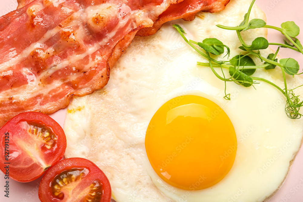 Tasty fried egg with bacon and tomatoes, closeup