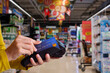 © Thanumporn - Paying with credit card in supermarket.