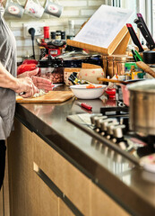 Canvas Print - Chef cuts cheese in the home kitchen, for cooking according to a recipe from the Internet