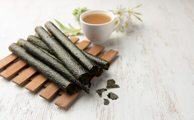 Wall Mural - Deep fried seaweed rolls,Snacks, Seaweed, Baked, Dried, Crispy on wood table