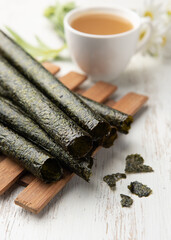 Wall Mural - Deep fried seaweed rolls,Snacks, Seaweed, Baked, Dried, Crispy on wood table