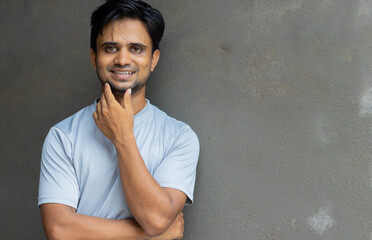 Wall Mural - Portrait of happy young Indian man 