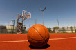 © Angelov - Top view orange ball for basketball lying on the rubber sport court. Sport red ground outdoor in the yard
