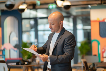 business man standing  in cafe or co working using laptop, man happiness and smiling in office