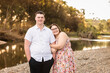© Austockphoto - Girlfriend cuddling into boyfriends arm standing near water smiling