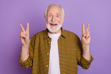 Poster - Photo portrait of optimistic granddad grey hair double v-sign wear stylish yellow checkered shirt isolated on lilac violet color background