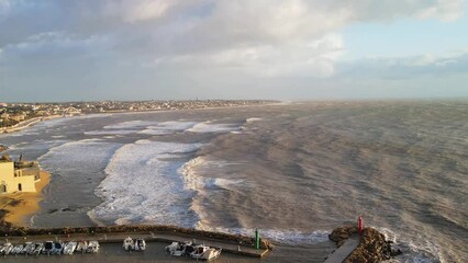 Sticker - Lighthouse along the coast during a storm. Aerial view from drone