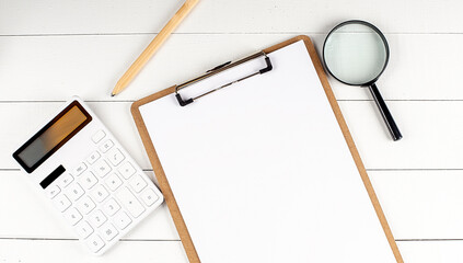 Poster - clipboard with white blank paper sheet, pen and calculator with copy space, top view. Business concept. background, flat lay.