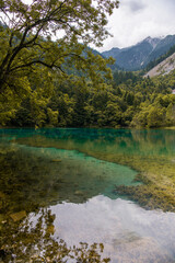 Bright blue waters and majestic mountains. Jiuzhaigou nature reserve and national park, China.