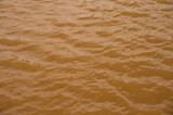 Fototapeta Kwiaty - Background lake surface ferrous brown water from coal mining pit water eternity burdens