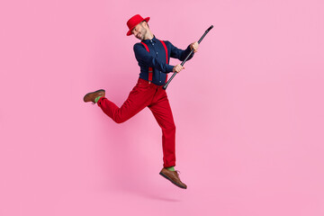 Poster - Full length photo of overjoyed cheerful person arms hold stick jumping isolated on pink color background