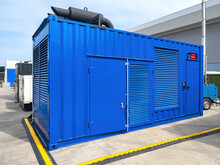 Container Power Plant. Blue Container On Concrete Pad. Portable Power Plant Based On Sea Container. Mobile Diesel Power Plant With Pipes On Roof. Equipment For Electrification Of Production