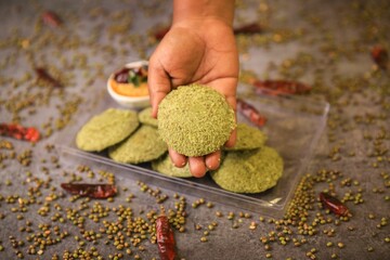 Green idly,south indian famous breakfast served with two chutneys closeup with selective focus