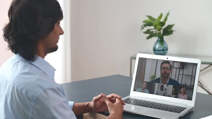 Wall Mural - Back view on the laptop screen with many profiles on it, an Indian guy is using computer app for video meeting, male employee involved online conference with coworkers, colleagues, virtual briefing