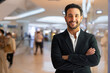 © Ranta Images - Portrait of happy handsome Hispanic businessman smiling with arms crossed