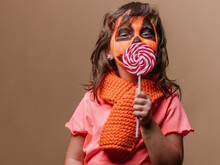 Elementary Girl Child Kisses A Colored Lollipop
