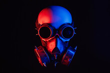 Human Skull In Steampunk Glasses And A Gas Mask With Red And Blue Neon Light On A Black Background