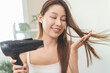 © Pormezz - Lifestyles domestic routine for women, Asian woman blowing hair with hairdryer at home.