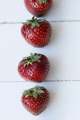 Strawberries on white wood background