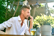 Businessman Speaking On Smartphone In Restaurant