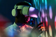 © ADDICTIVE STOCK - Serious black man touching large screen while exploring virtual reality in modern headset