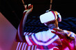 © ADDICTIVE STOCK - Black man looking at imaginary object while exploring cyberspace in VR glasses