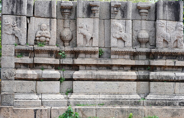 Wall Mural - Bas relief ancient historical carvings in the stone wall at Mahabalipuram temple, Tamilnadu, India.